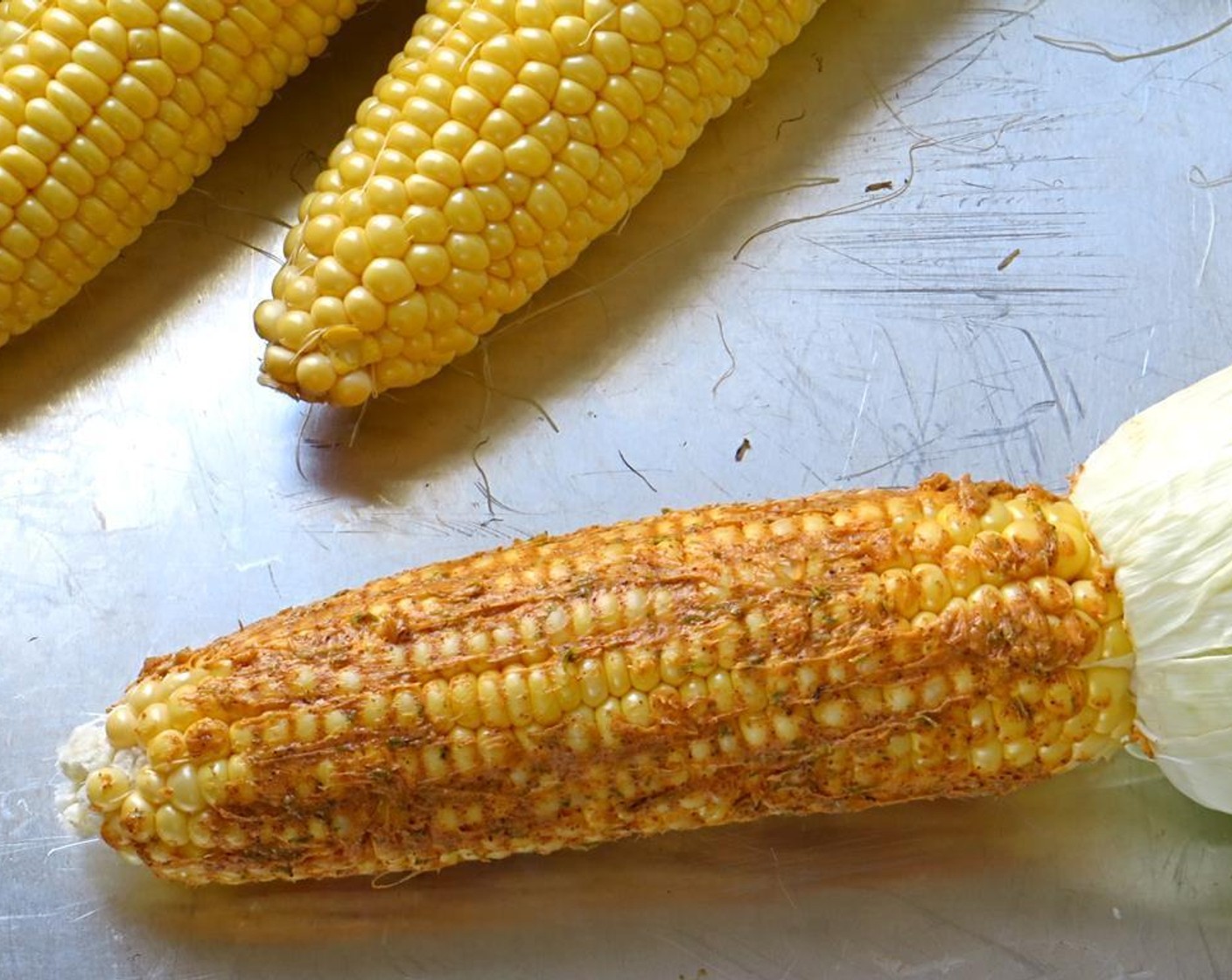 step 3 Brush the compound butter onto the corn, evenly covering each corn cob.