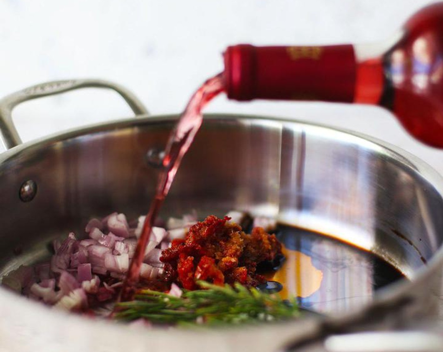 step 1 Chop Shallot (1) and place in a large skillet with Fresh Rosemary (3 sprigs), Sun-Dried Tomatoes (4 Tbsp), Rosé Wine (3 cups), and Balsamic Vinegar (1 Tbsp). Cook over medium heat and bring to a simmer. Cook down the wine until reduced by half.