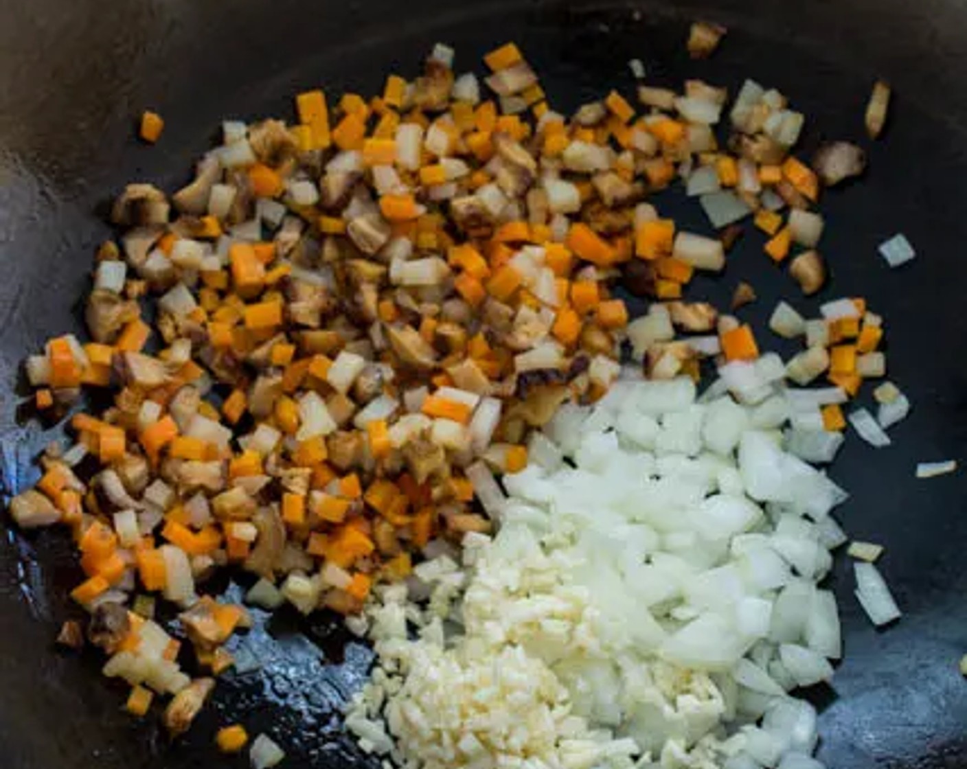 step 8 Add the Yellow Onion (1/2) and Garlic (3 cloves) to the wok, then stir-fry for 1 minute.