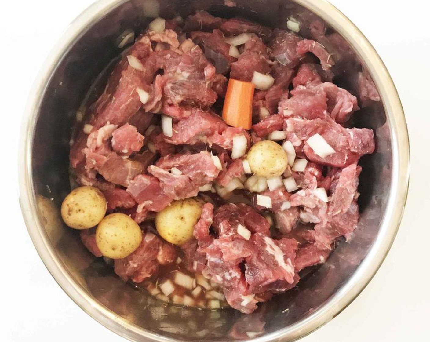 step 1 Place the Lean Beef Stew Meat (7 cups), Low-Sodium Beef Broth (4 cups), Baby Potatoes (1.5 lb), Carrots (2 cups), White Onion (1), Tomato Paste (2 Tbsp), Worcestershire Sauce (1 Tbsp), Garlic (4 cloves), Bay Leaf (1), and Fresh Thyme (1 tsp) in a large crock pot or instant pot.