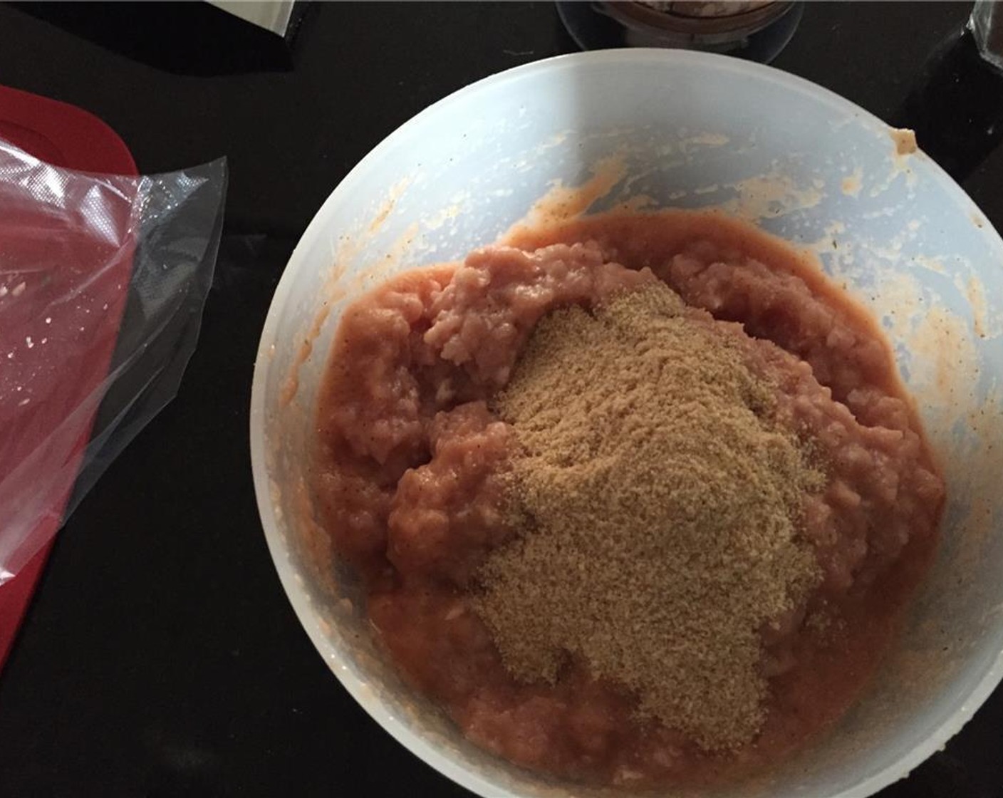 step 5 In a large mixing bowl, add Ground Beef (7 oz) and Ground Pork (7 oz). Add the blender mixture, Dried Oregano (1 tsp), Breadcrumbs (1/3 cup), Salt (to taste), and Ground Black Pepper (to taste).