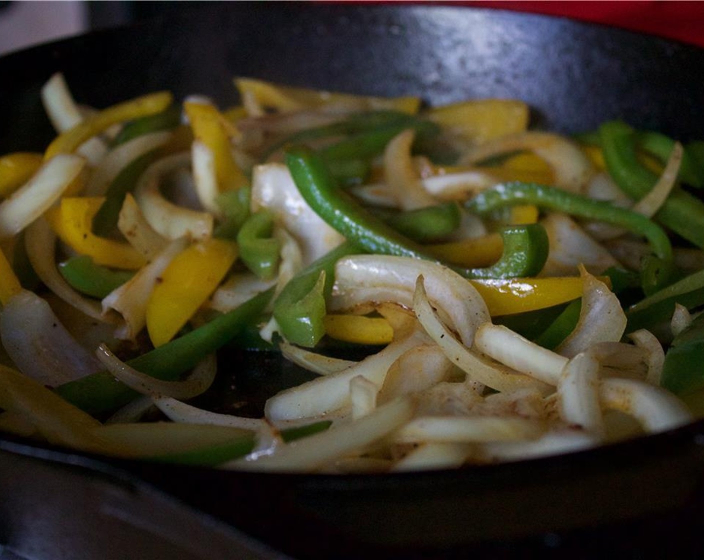 step 8 Remove the chicken thighs and set aside.  Add in the sliced onion and bell peppers. Add some color and continue to cook over high heat for 3 minutes. Then add in the minced garlic and Crushed Red Pepper Flakes (1 pinch).