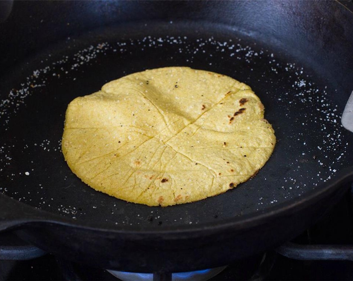 step 12 Once you've finished rolling, preheat a non-greased cast iron skillet over medium high/high heat. Place tortillas on the hot pan one at a time and cook for about 45 seconds - 1 minute per side.