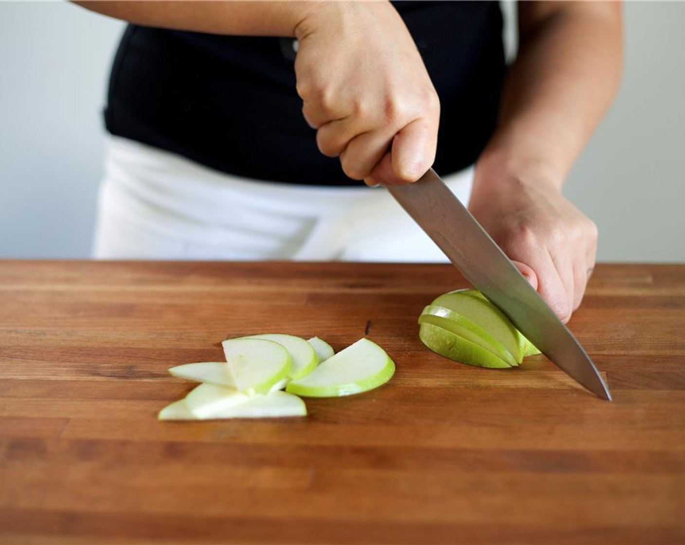 step 2 Slice the Granny Smith Apple (1) in half then into quarters. Remove the core by placing the flat cut side down on the cutting board and slice at an angle above the core to remove. Slice the apple into quarter inch slices lengthwise, and set aside.