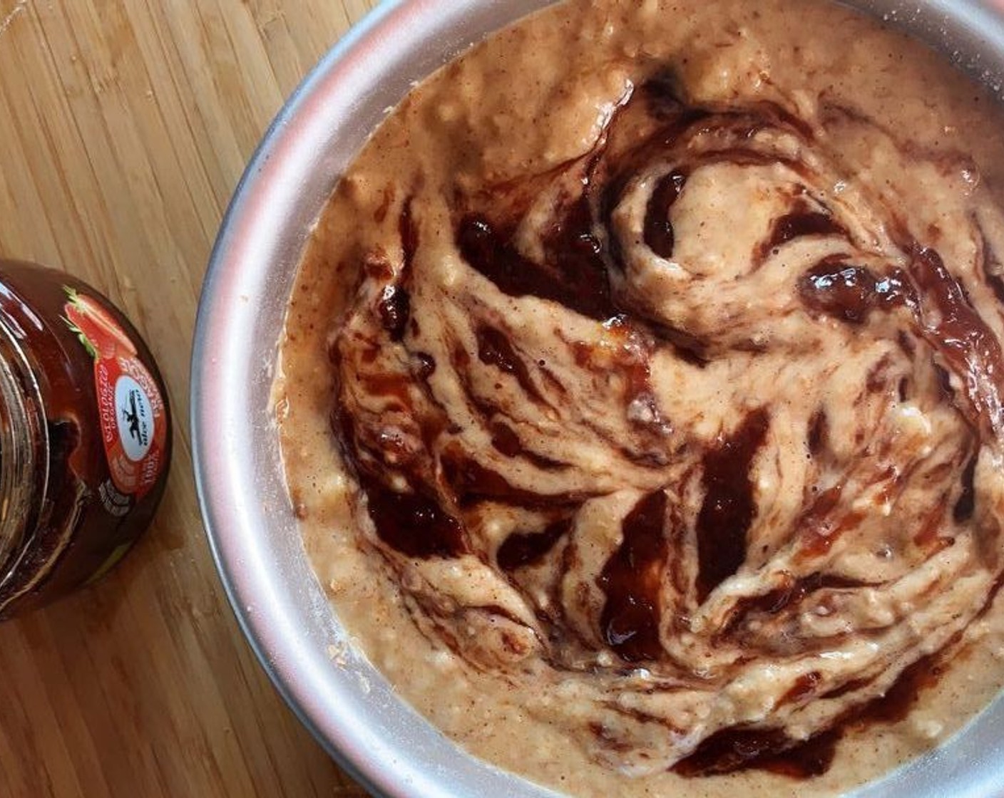 step 5 Drizzle the Strawberry Jam (1/2 cup) on top and using the back of a spoon mix in the jam with the regular batter. Swirl it around a little too.