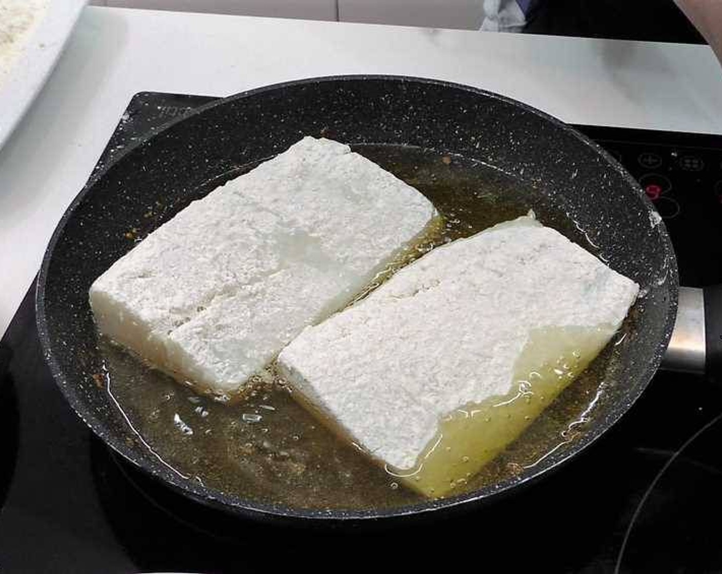 step 12 Fry the cod fillets in a good amount of Olive Oil (as needed). Once the flour coating has turned golden brown you can remove them from the pan, as the fillets will finish cooking in the oven.