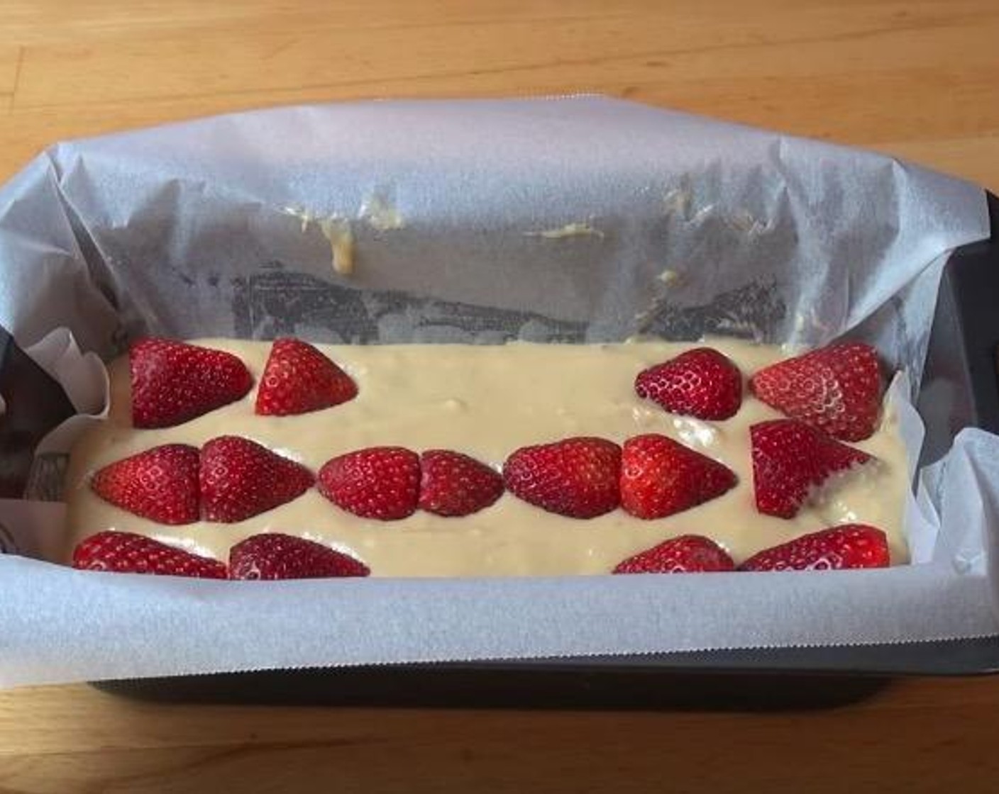 step 4 Transfer the mixture into a loaf tin, greased and lined with baking paper. Smooth the surface until even and top with Fresh Strawberry (3/4 cup).