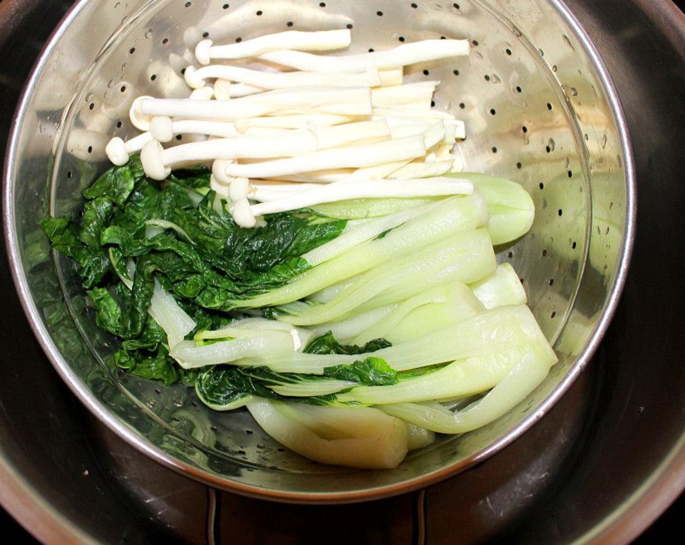 step 11 Place the blanched bok choy and Enoki Mushrooms (2 cups) in a steamer and steam, covered, until just heated through.
