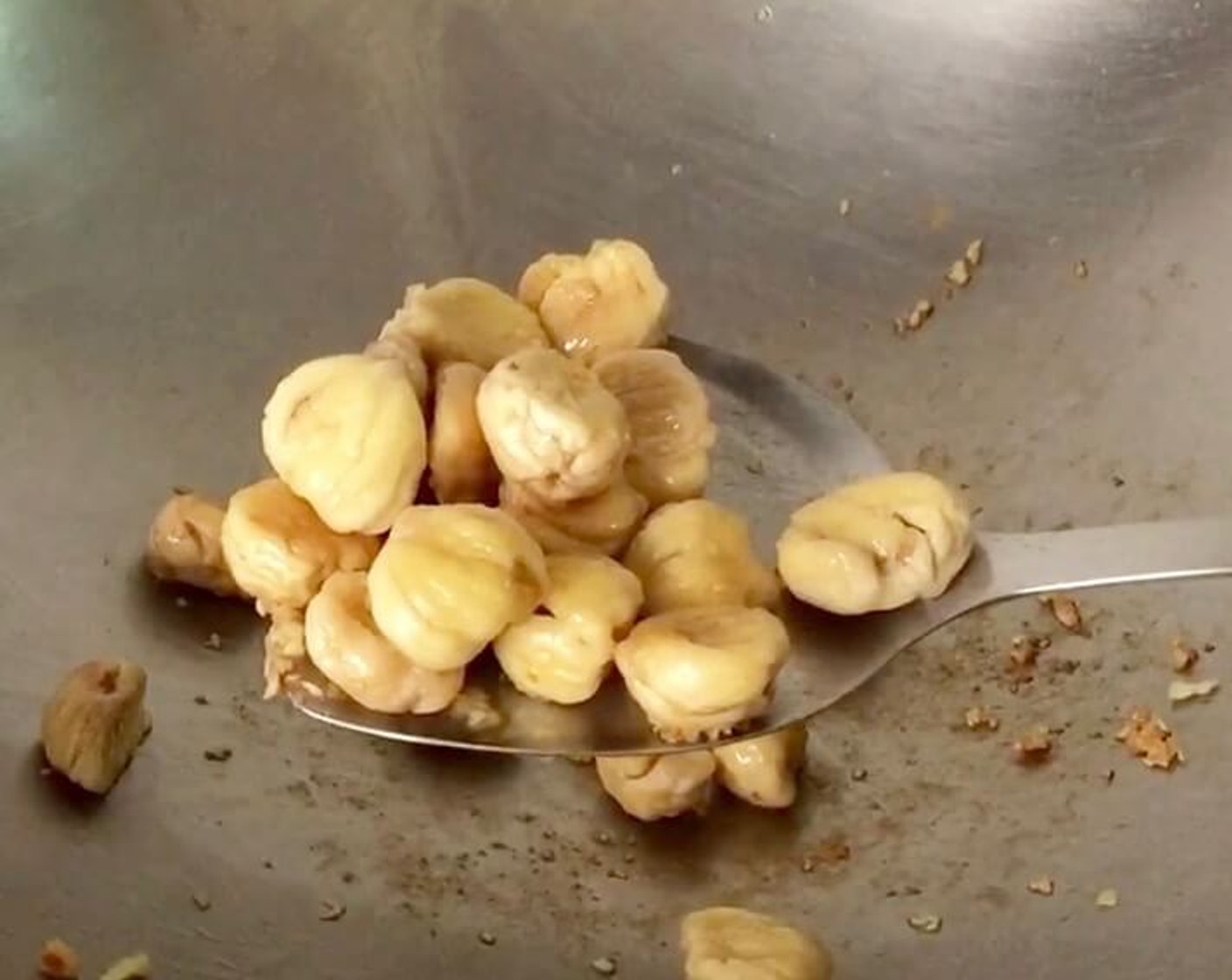 step 13 In the same wok, fry the chestnuts until they brown slightly. Remove from wok and place in a bowl.