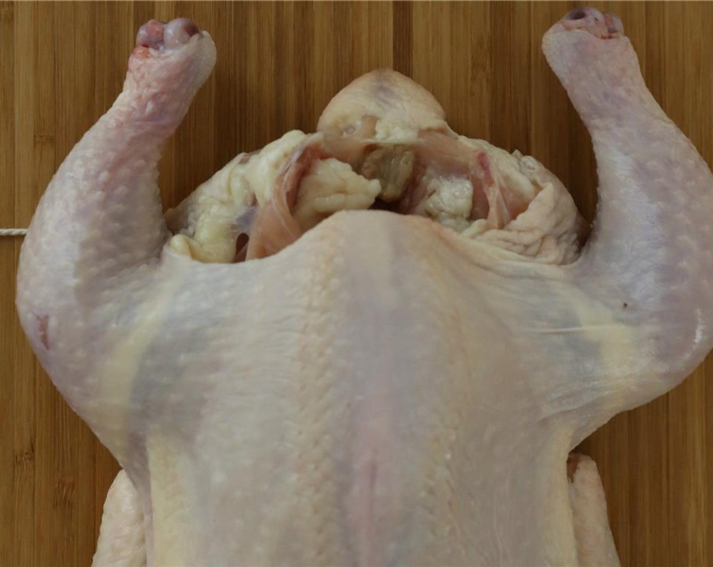step 1 Start by patting the Whole Chicken (1) dry with a paper towel. Lay it down breast-side up with the legs pointed away from you. Place the butcher twine underneath the tail and pull it up on both sides making sure it is even. You will need about 30-inches of twine.