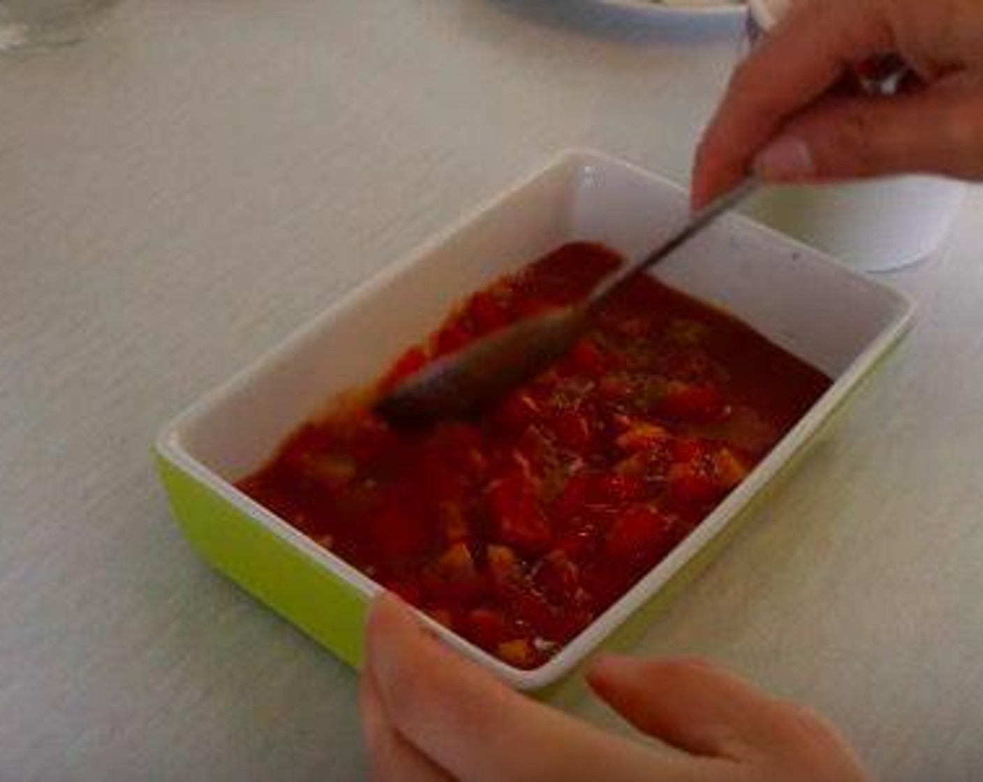 step 3 On top of the tomato sauce, add the Tomato (1 cup) and then sprinkle some of the Dried Oregano (1 tsp) and Fresh Parsley (1 Tbsp).