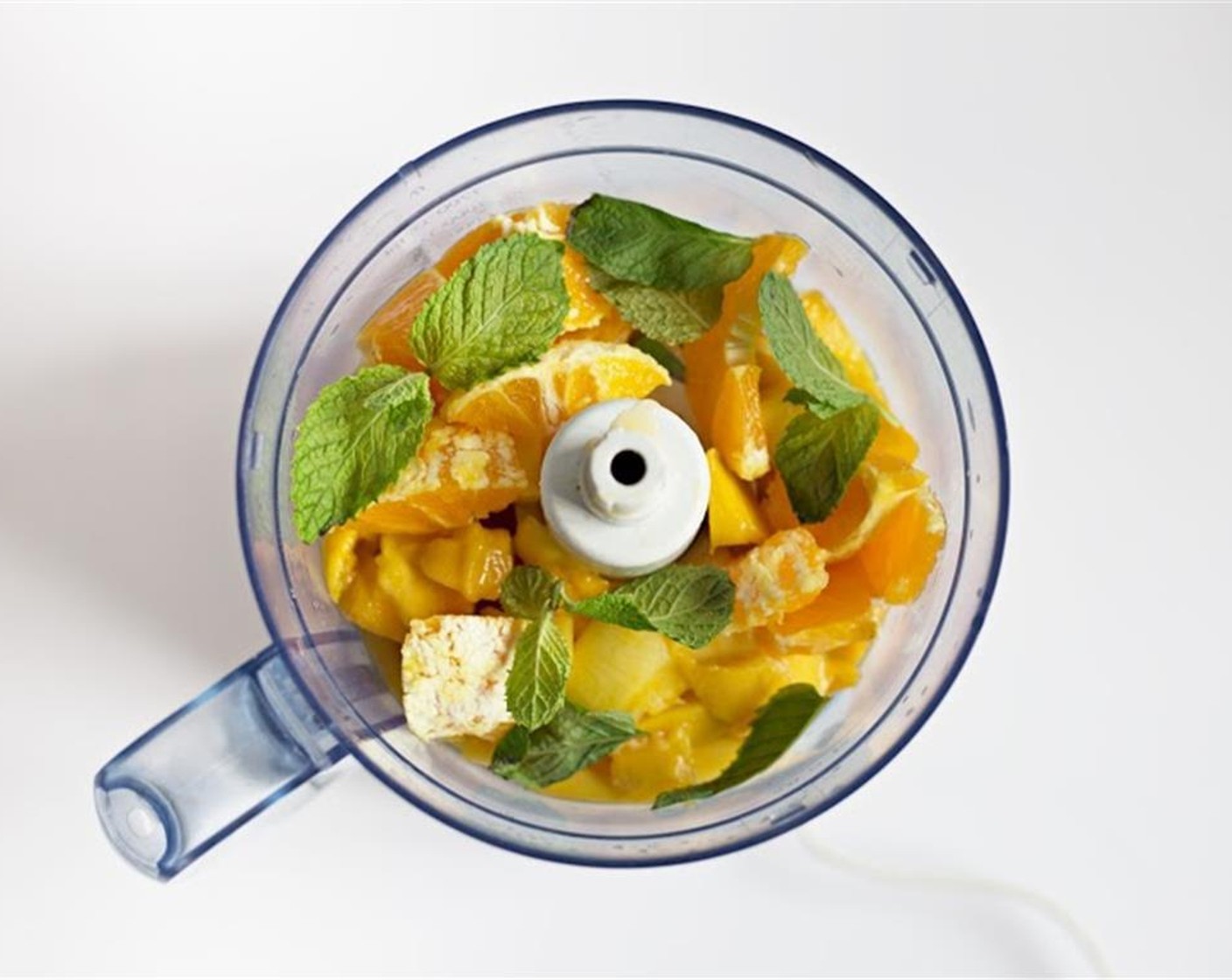 step 1 Blend Fresh Mango Chunks (3 cups), Orange (1 cup), Fresh Mint (1 1/2 sprigs), and Prosecco Wine (to taste) in a food processor or blender.