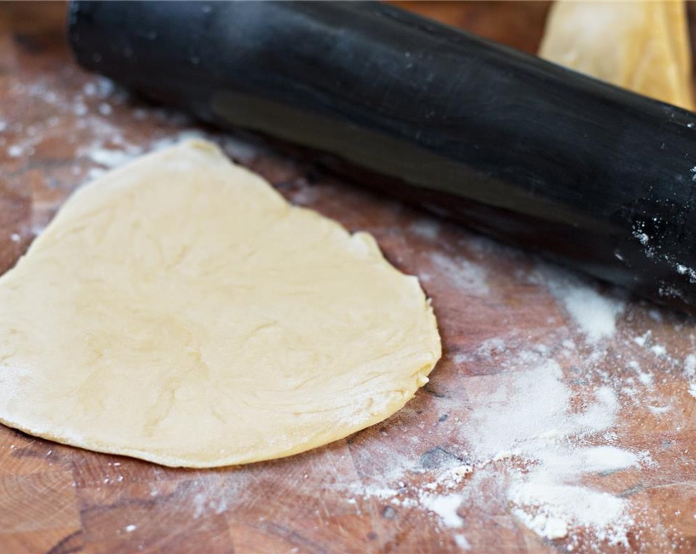 step 5 Tear or slice the dough into manageable pieces—usually as many as the number of people you're feeding. Dust your countertop or cutting board heavily with flour, then use a rolling pin to make the dough as thin as you can.