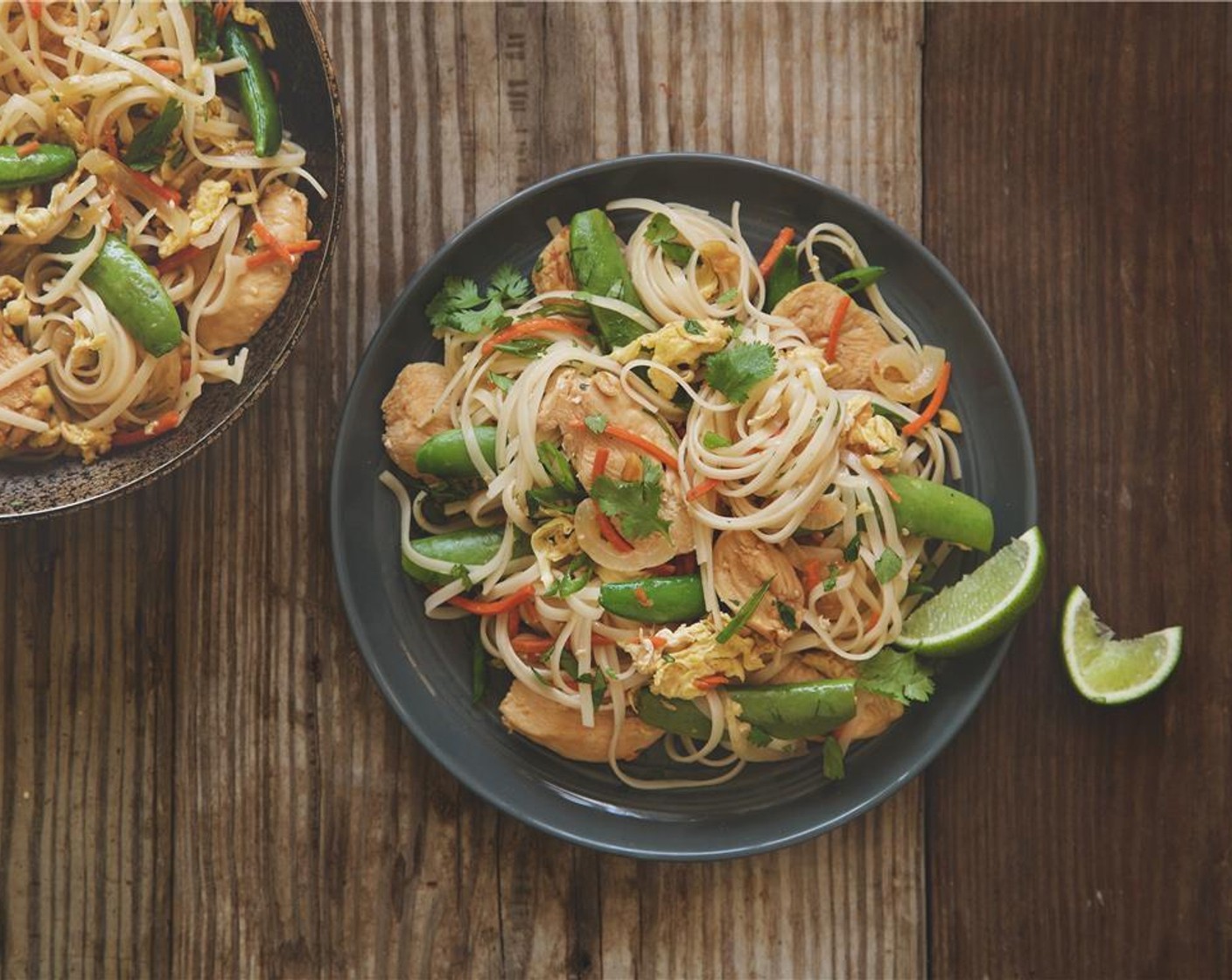 step 13 Divide the pad thai evenly in the cetner of two plates. Garnish with lime wedges and cilantro leaves. Enjoy your weeknight Thai adventure!