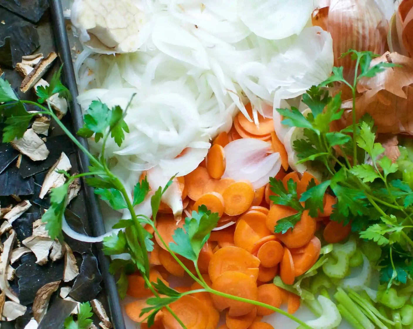 step 4 Add Onions (2), Carrot (1), Celery (1 stalk), Garlic (1 head), and Fresh Parsley (6 sprigs) and toss to combine.