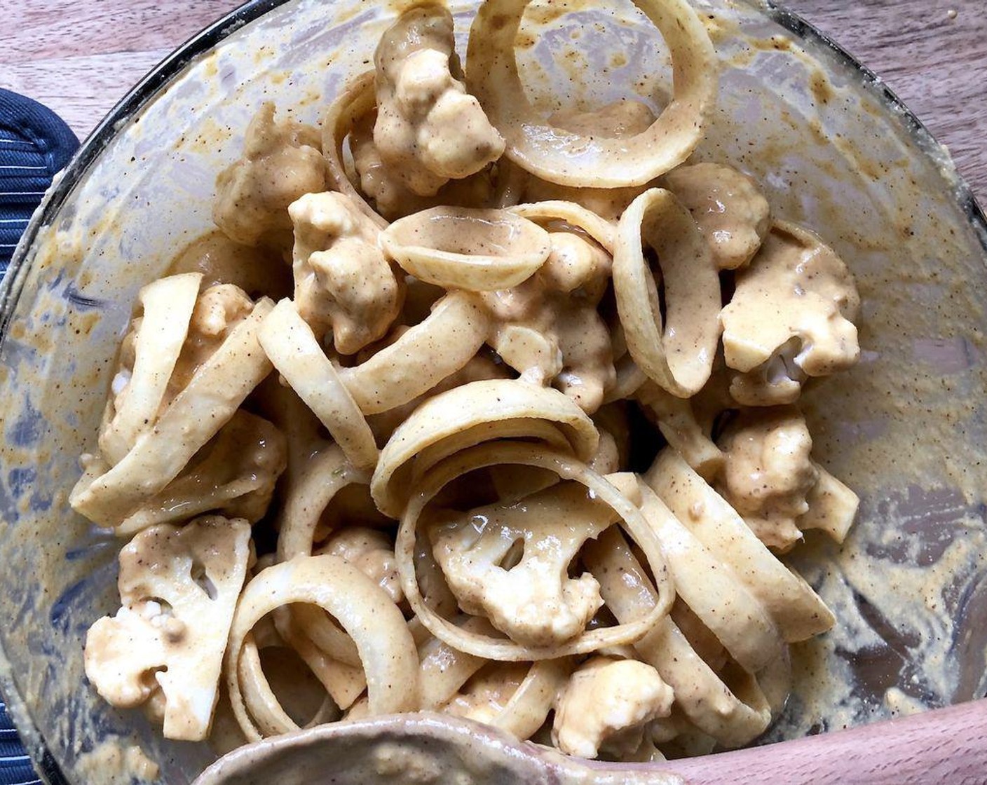 step 3 Once a thick, smooth batter forms, add the Cauliflower Florets (3 cups) and Onions (2). Gently stir until all surfaces are coated, adding 1 to 2 tablespoons of water if needed.