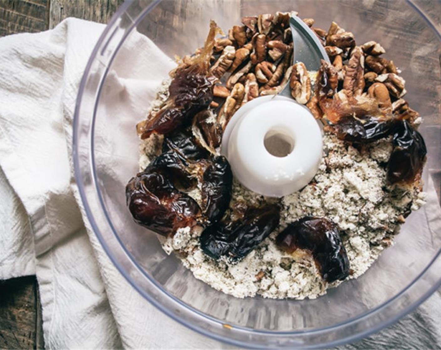 step 1 Add Pecans (1 cup), Almond Meal (1/2 cup), Oats (1/2 cup), Vanilla Extract (1 tsp), and Medjool Dates (6) to the bowl of a food processor.