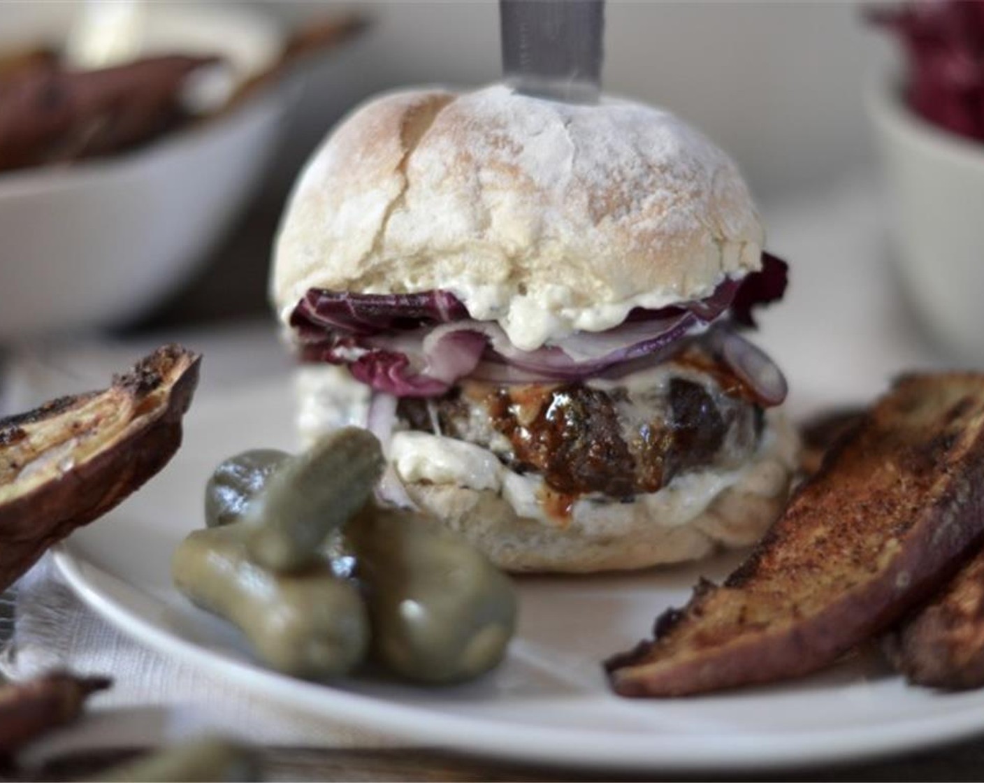 step 6 Put together your burger simply with the blue cheese mayonnaise and Red Onions (to taste) and then serve with the vinegary tang of Pickled Cucumbers (to taste) on the side to cut through the richness.