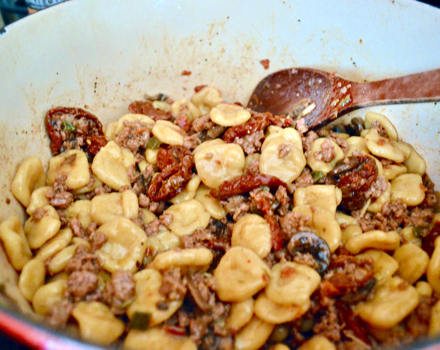 step 6 Drain the pasta when it's tender and toss it into the pot with the sausage and mushroom mixture. Stir thoroughly.