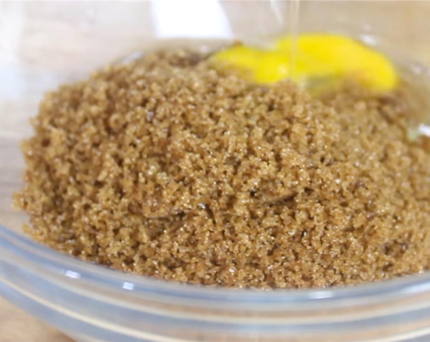 step 3 In a mixing bowl, add Brown Sugar (1 cup), Granulated Sugar (1/2 cup), and Eggland's Best Classic Egg (1). Using a spatula, cream them together.