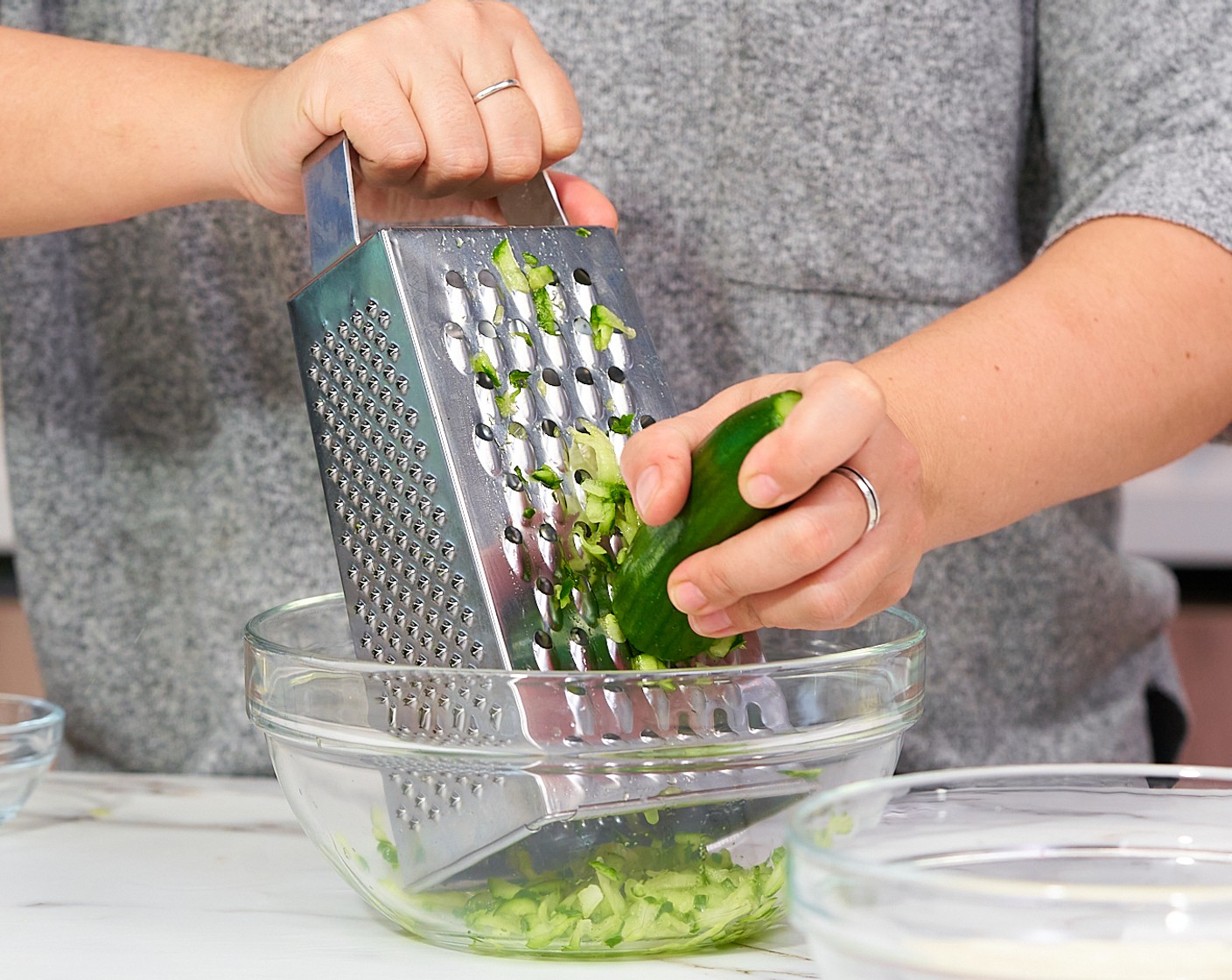 step 4 To make the tzatziki, shred the Cucumber (1) on the largest hole of the box grater.