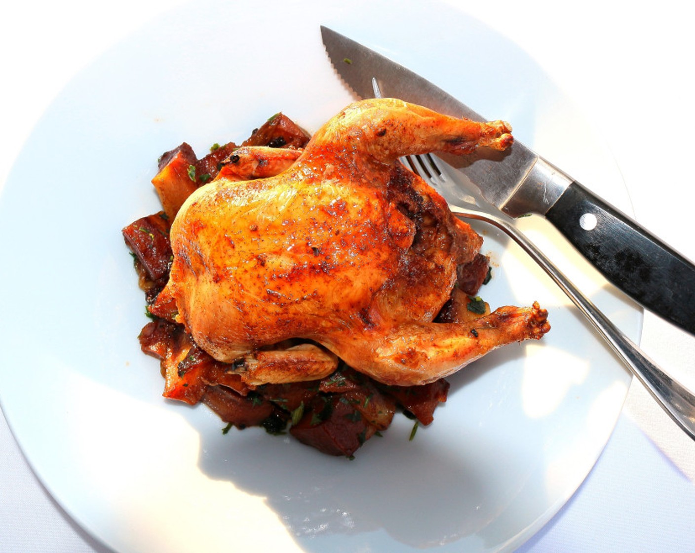 step 8 Place a cornish hen on top of the potatoes on each plate. Serve with a simple green salad. Enjoy!