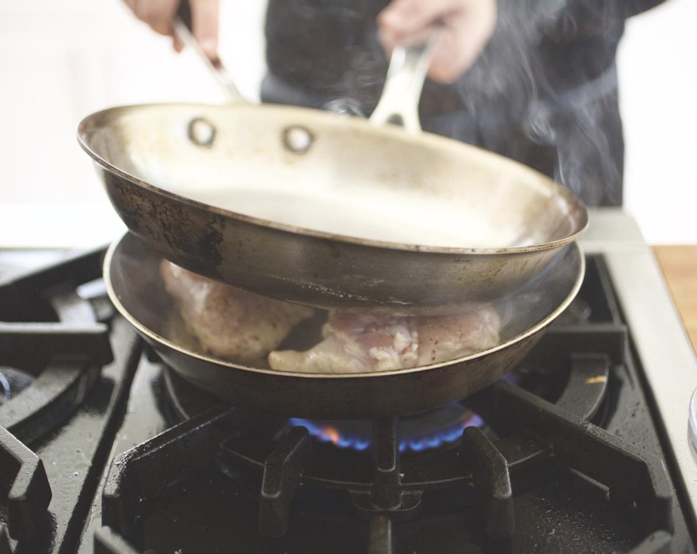 step 8 Press another medium sauté pan down on top of the chicken. Cook until crisp, about 10 minutes.