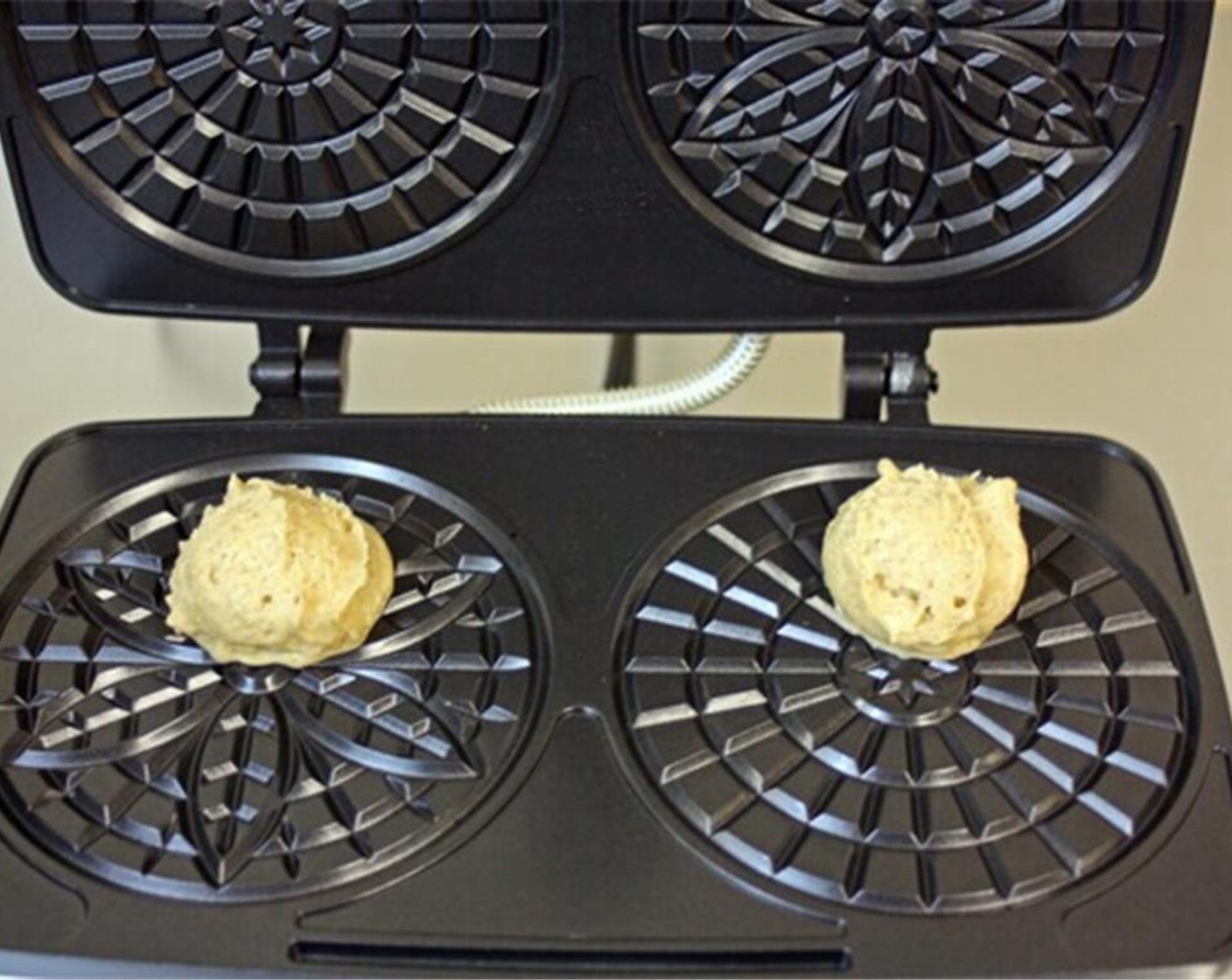 step 7 Place a rounded tablespoon of batter into the center of each pizzelle form. You may want to position the batter a little towards the back of the form if you find that it pushes the batter up when you close the lid.