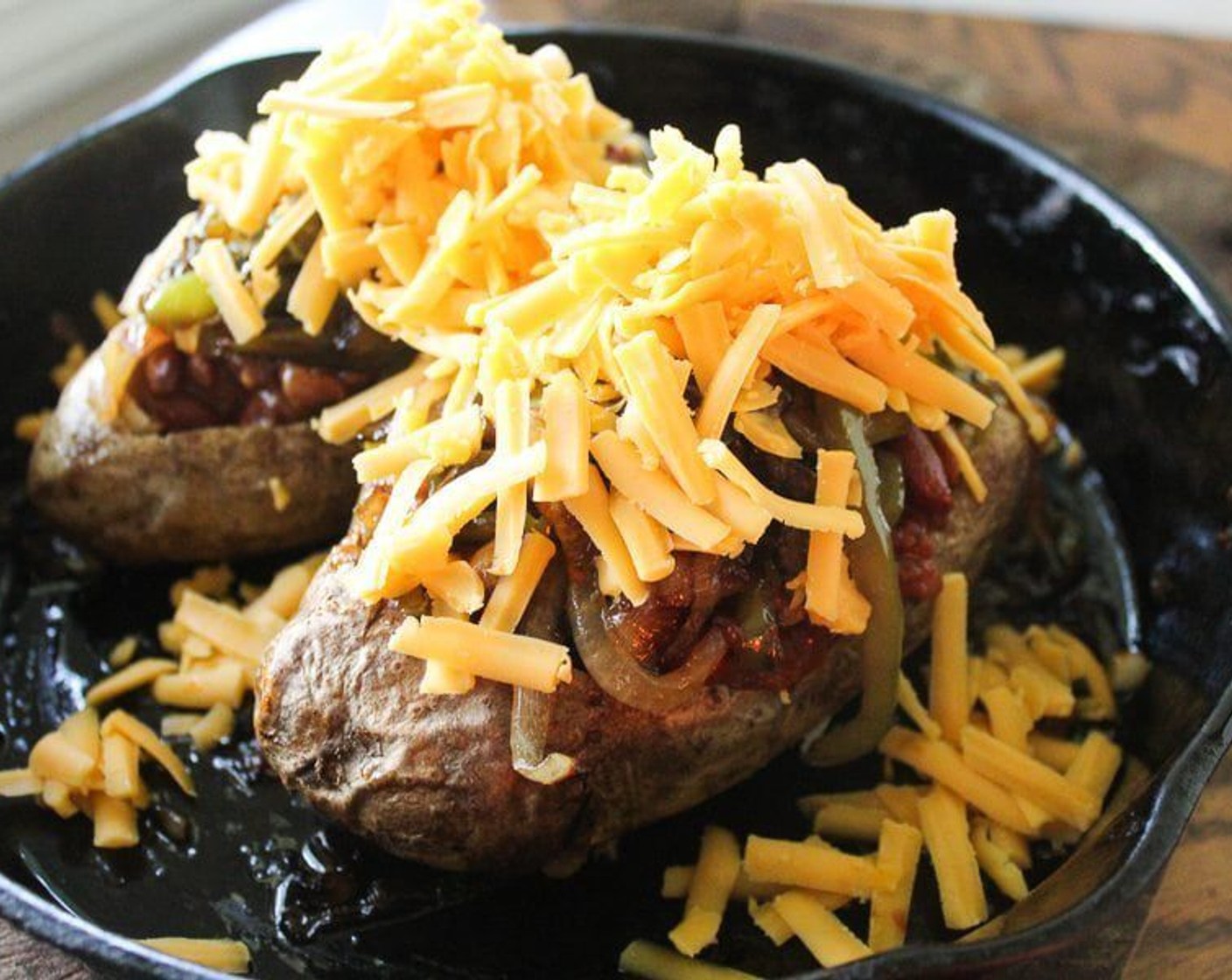 step 9 Top each chili potato evenly with onions and peppers, then with the Sharp Cheddar Cheese (1 cup).