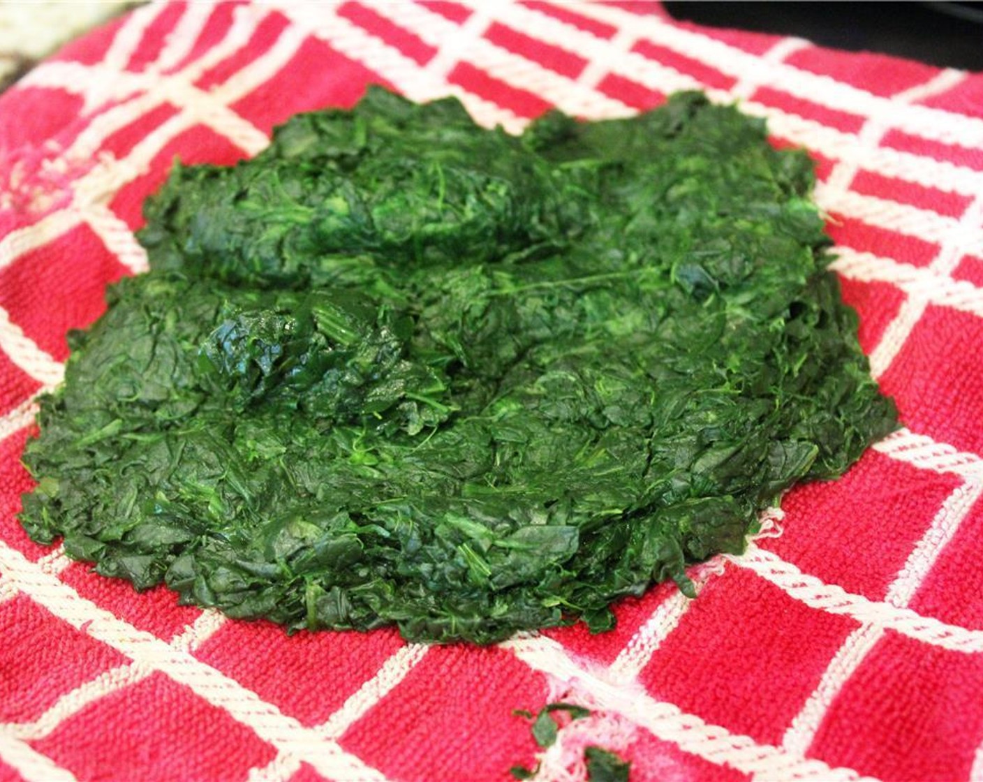 step 2 Thaw the Frozen Spinach (1 pckg). Drain by putting it in to a kitchen towel, then squeezing it.