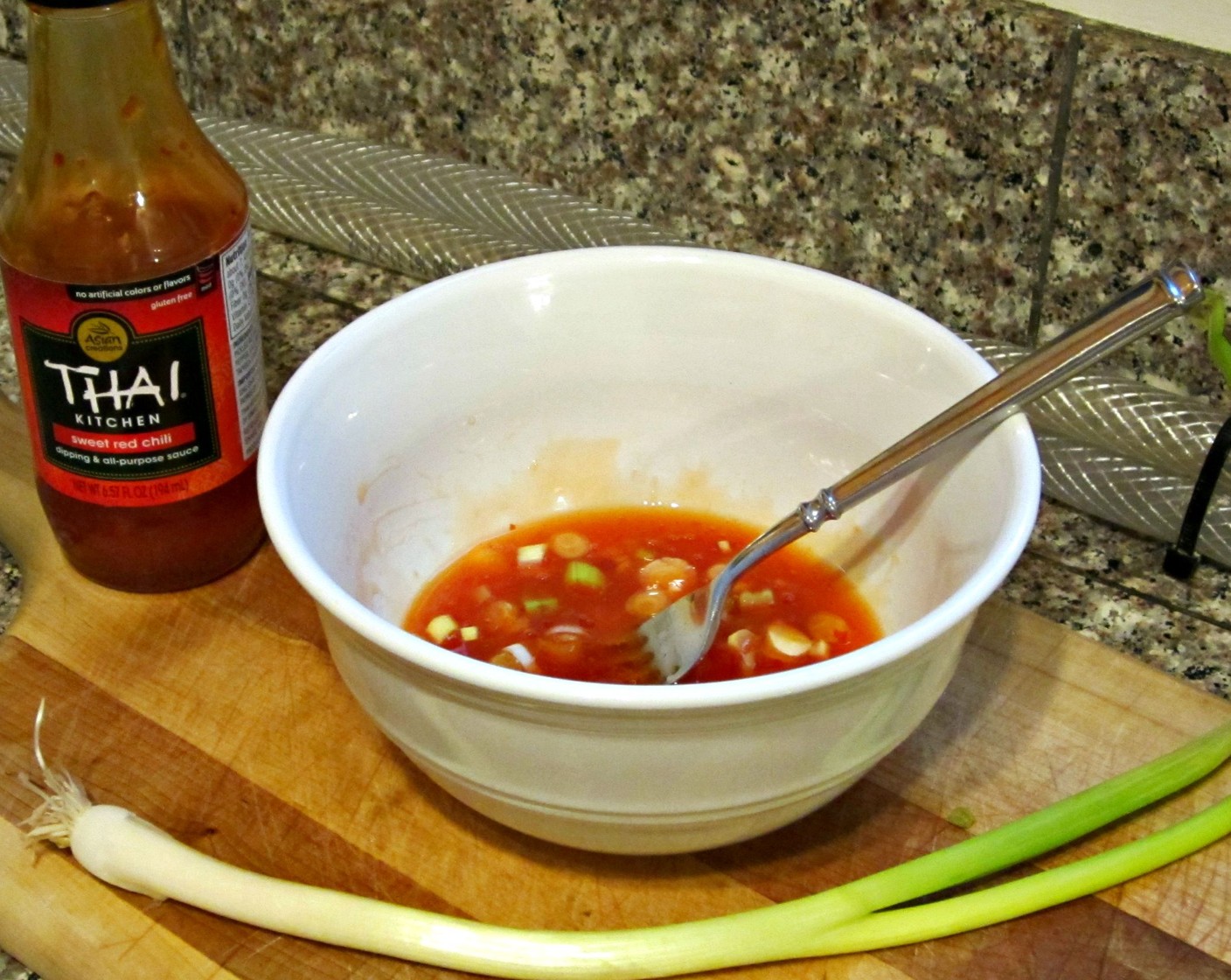 step 9 While the eggplant is cooking, mix your Thai Sweet Chili Sauce (1/4 cup) with Lime (1/4), Scallion (1 Tbsp), and season with salt and pepper.