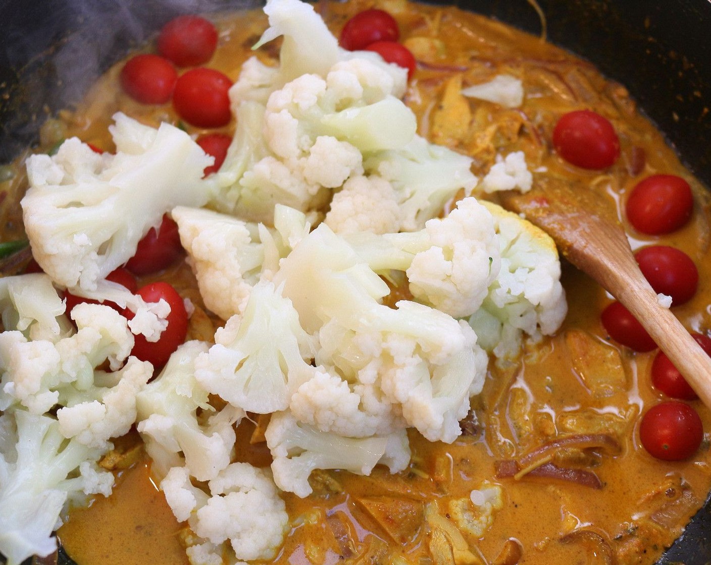 step 5 Add Cauliflower (1 head) and Grape Tomatoes (20). Simmer until veggies are heated.