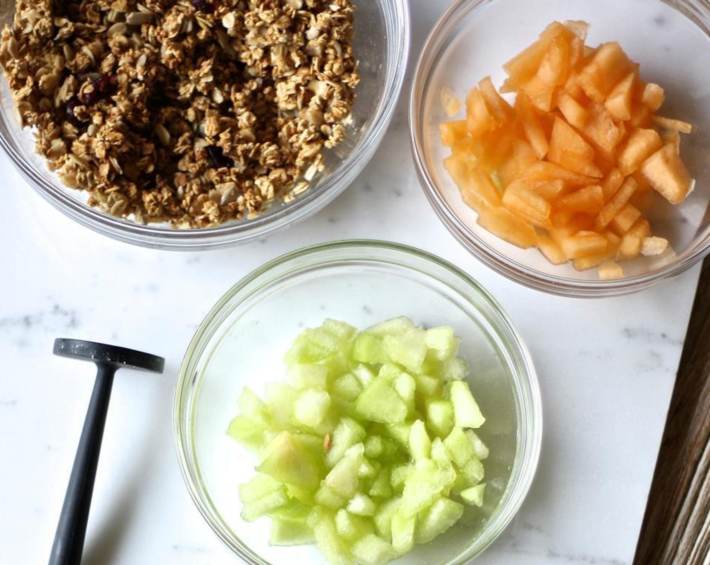 step 1 Finely dice the Honeydew Melon (1/4 cup) and Cantaloupe (1/4 cup). Place each in a separate bowl, along with the Granola (2 cups).