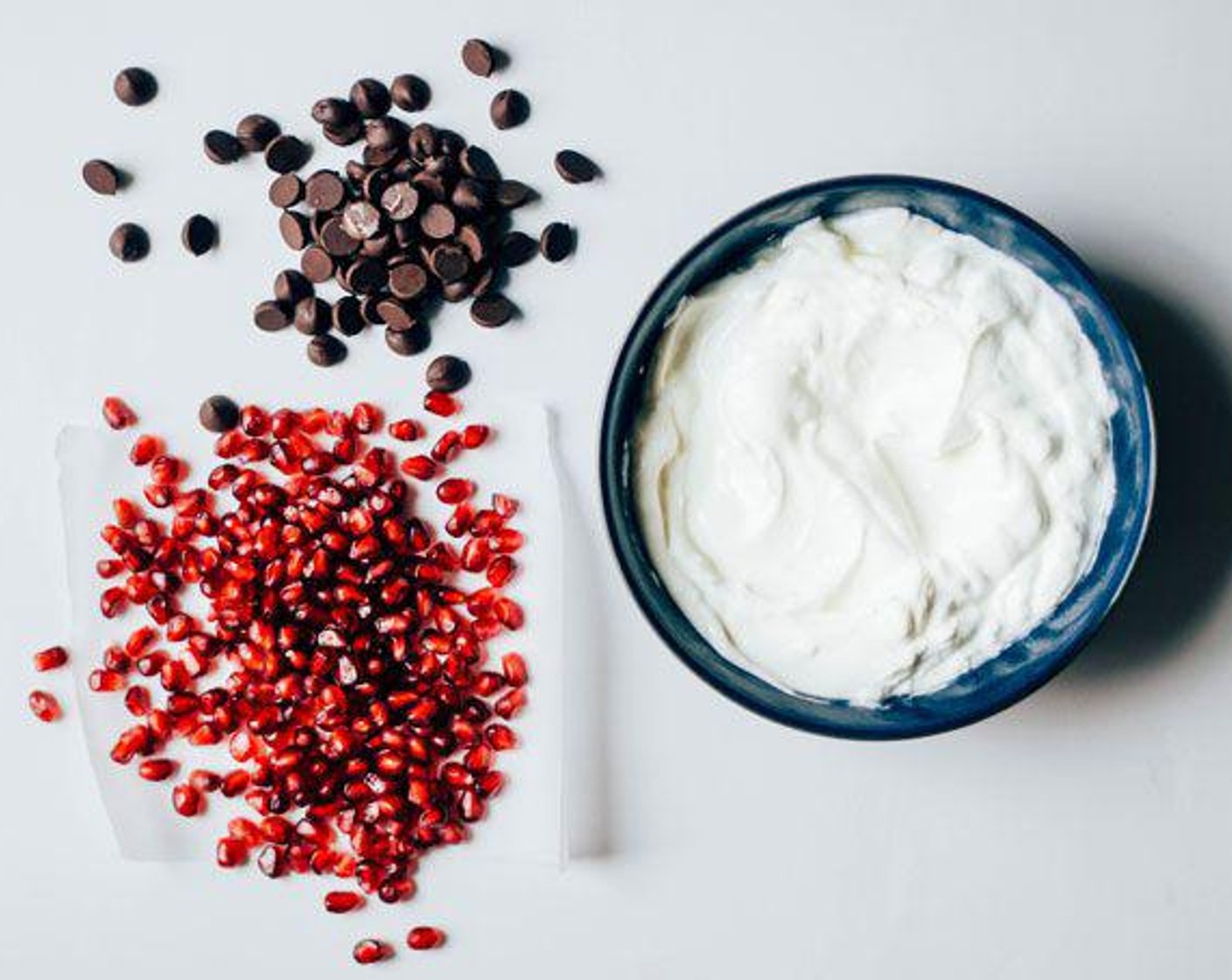 step 1 Into the Greek Yogurt (2 cups), mix the Pomegranate Seeds (1/4 cup) and Dark Chocolate Chips (2 Tbsp). Add Caster Sugar (1 Tbsp) if needed.