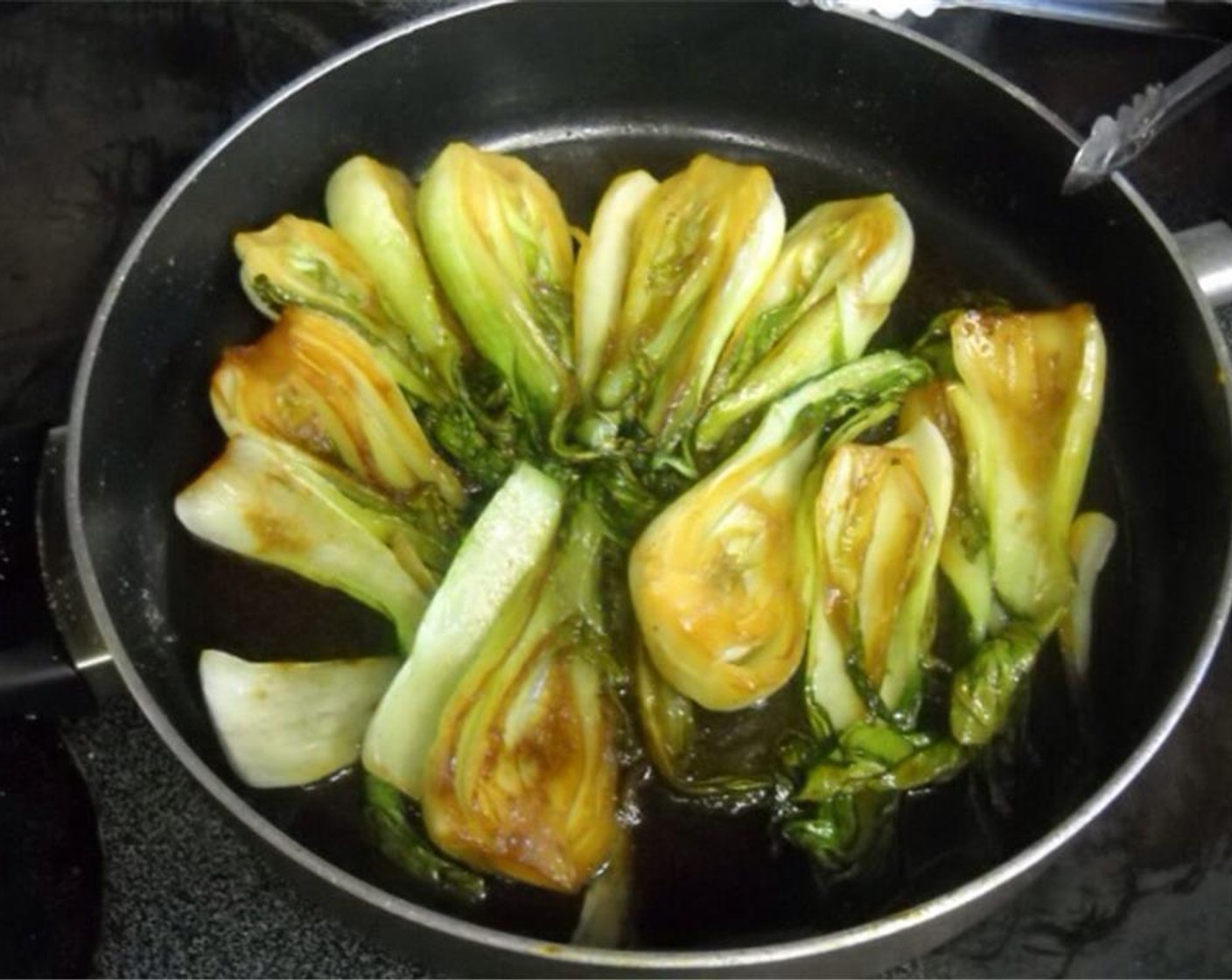 step 3 Add bok choy and cook until the green parts of the leaves turn bright green and the stalks become slightly translucent.