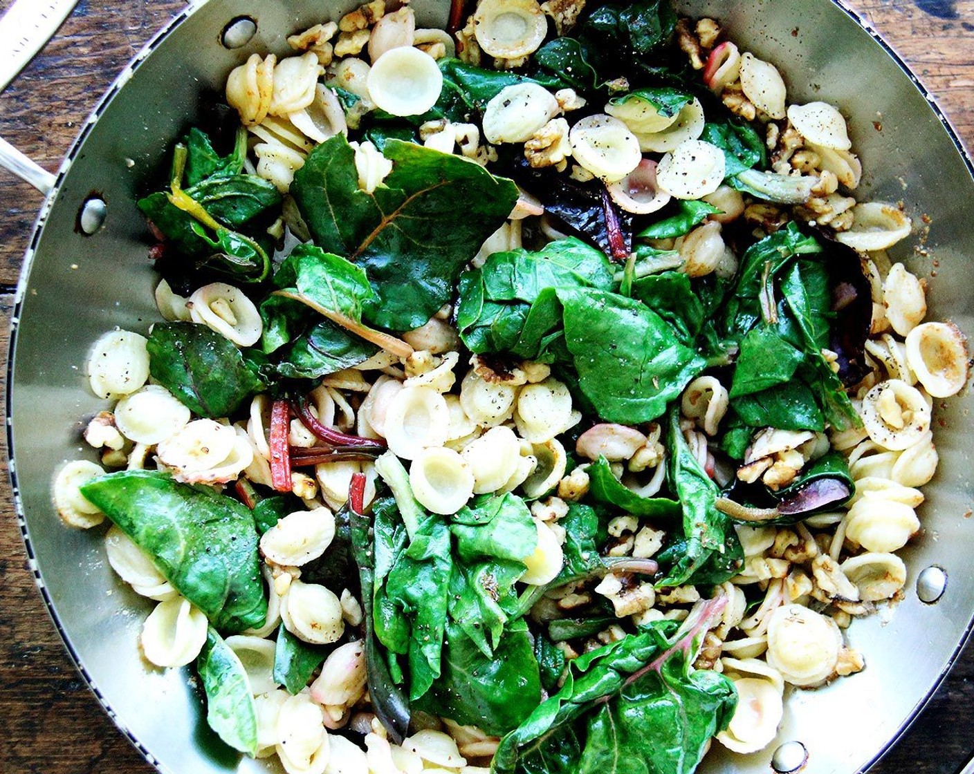 step 7 Bring the brown butter back up to temperature over medium or medium-high heat; add the pasta and greens to the pan. Add the walnuts and toss to coat. Sprinkle Pecorino Romano Cheese (1/4 cup) over top and toss again. Taste. Add more Salt (to taste) and Freshly Ground Black Pepper (to taste). If necessary add some of the pasta cooking liquid to the pan.