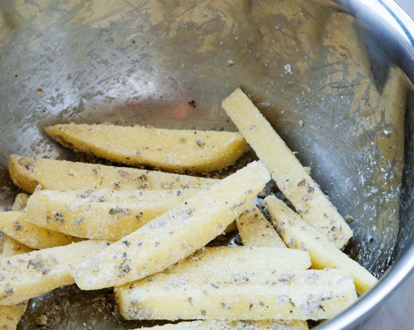 step 4 Season the Potatoes (2) with Dried Mixed Herbs (to taste), Coconut Oil (2 Tbsp), Corn Starch (2 Tbsp), Salt (to taste), and Ground Black Pepper (to taste).