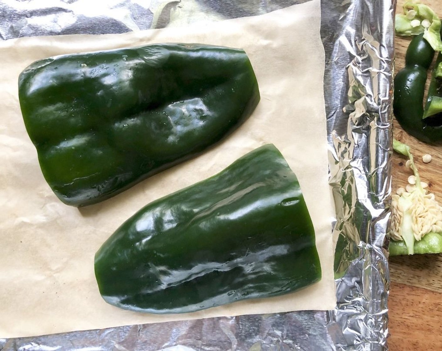 step 2 Cut Poblano Pepper (1) pepper in half lengthwise; remove stems and seeds. Place cut sides down on a foil-lined baking sheet.