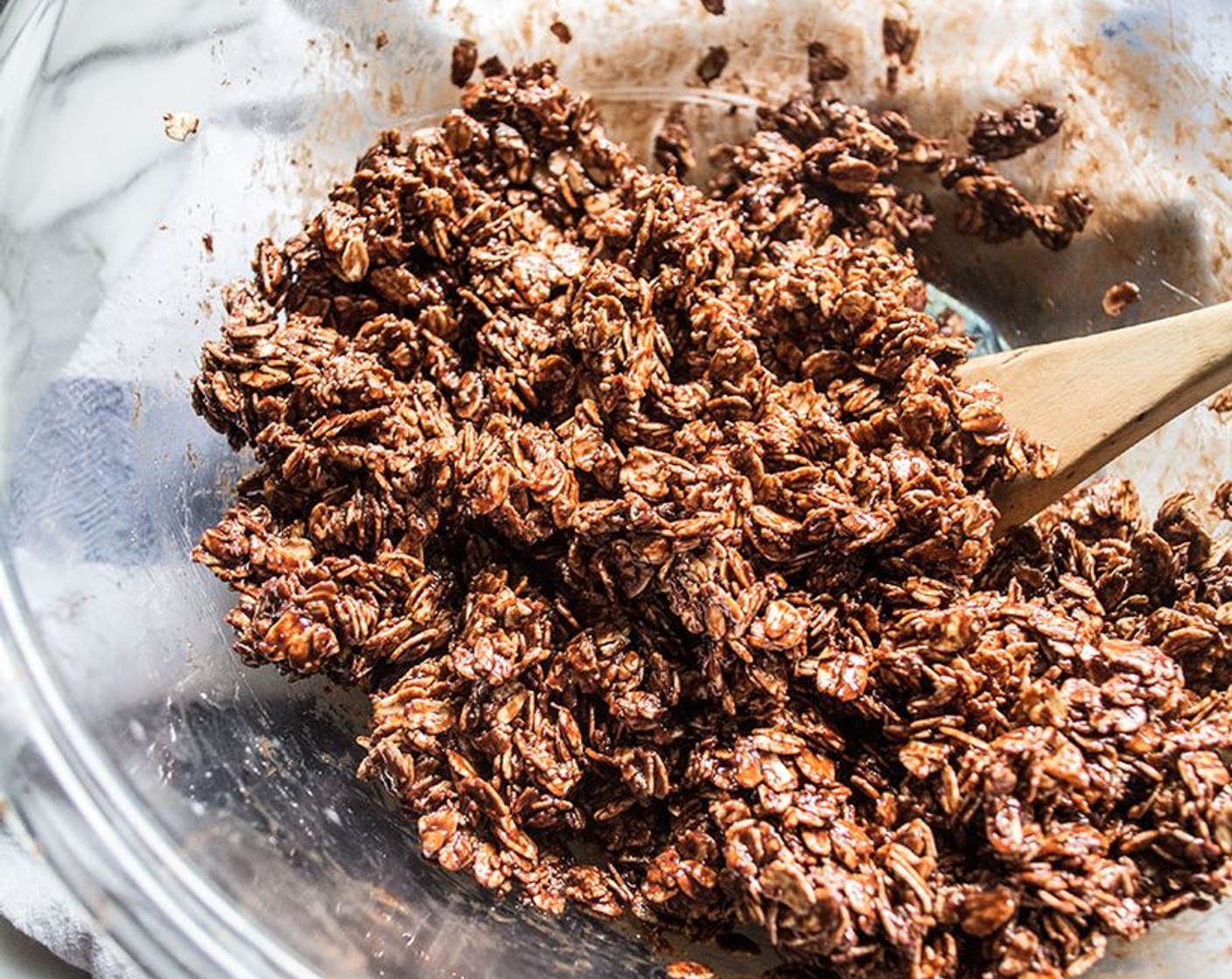 step 5 Pour chocolate mixture over whole oats, stirring with large spoon or tossing with hands until all oats are coated with the mixture.