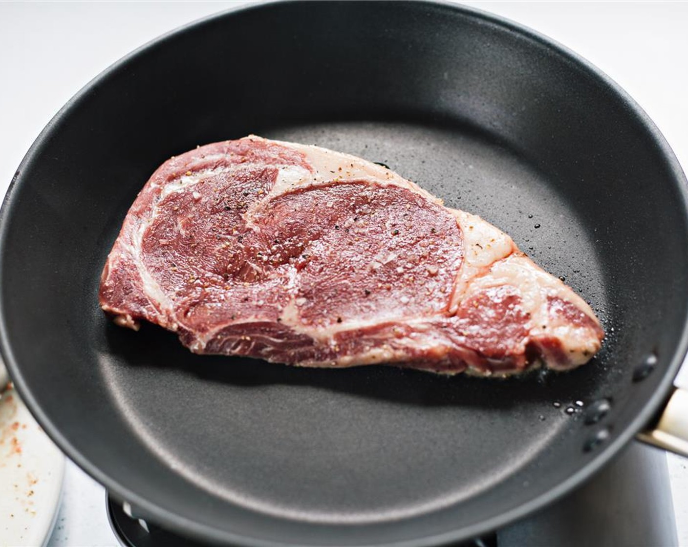 step 5 Place steak in hot pan, and sear on side one for 6 minutes.