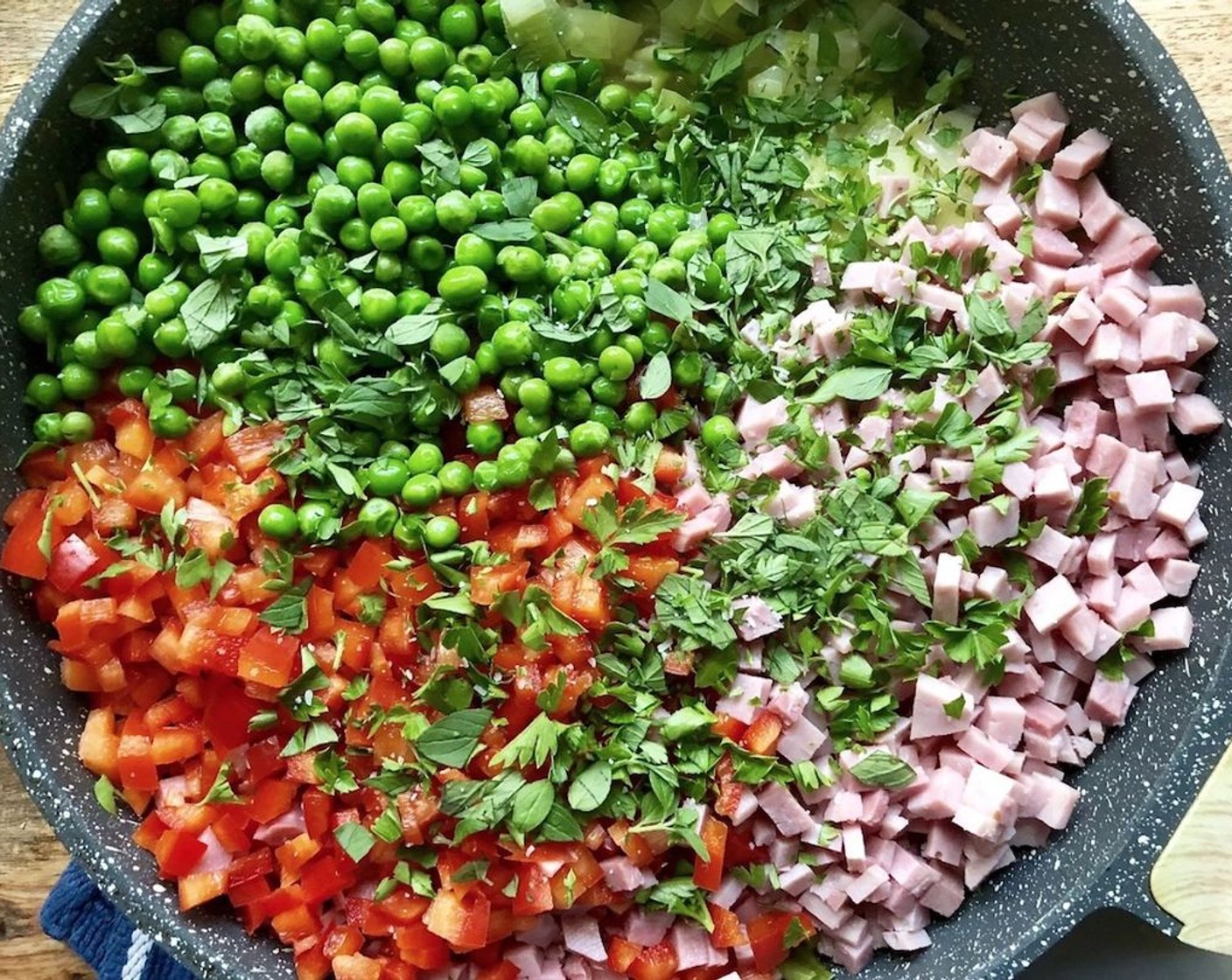 step 7 Stir in cubed Cooked Ham (1 lb), Red Chili Peppers (2 cups), Frozen Green Peas (1 cup), Fresh Oregano (2 Tbsp), and Fresh Parsley (2 Tbsp). Cool for 10 minutes.
