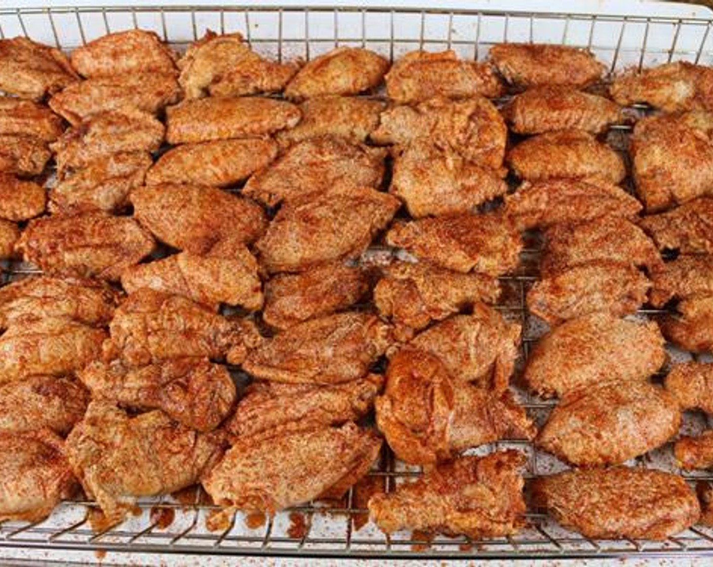 step 6 Drain the wings and arrange on a cooking rack. Season each side with the All-Purpose Spice Rub (1/2 cup) and Barbecue Rub (1/2 cup).
