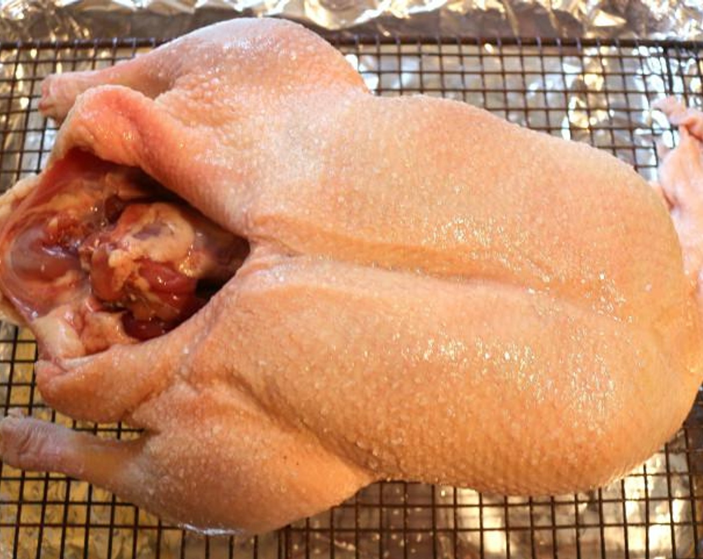 step 1 Preheat oven to 400 degrees F (200 degrees C), then prick skin and fat of Whole Duck (1) all over, remove excess fat-flaps and season duck generously inside and out side with the Kosher Salt (to taste).
