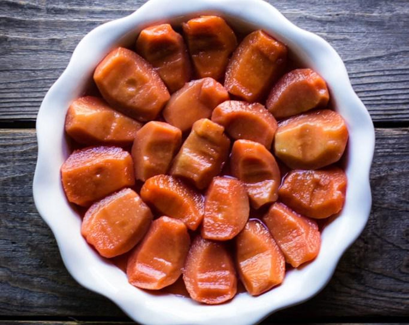 step 8 Arrange the poached quince on top of poaching liquid, rounded side down.