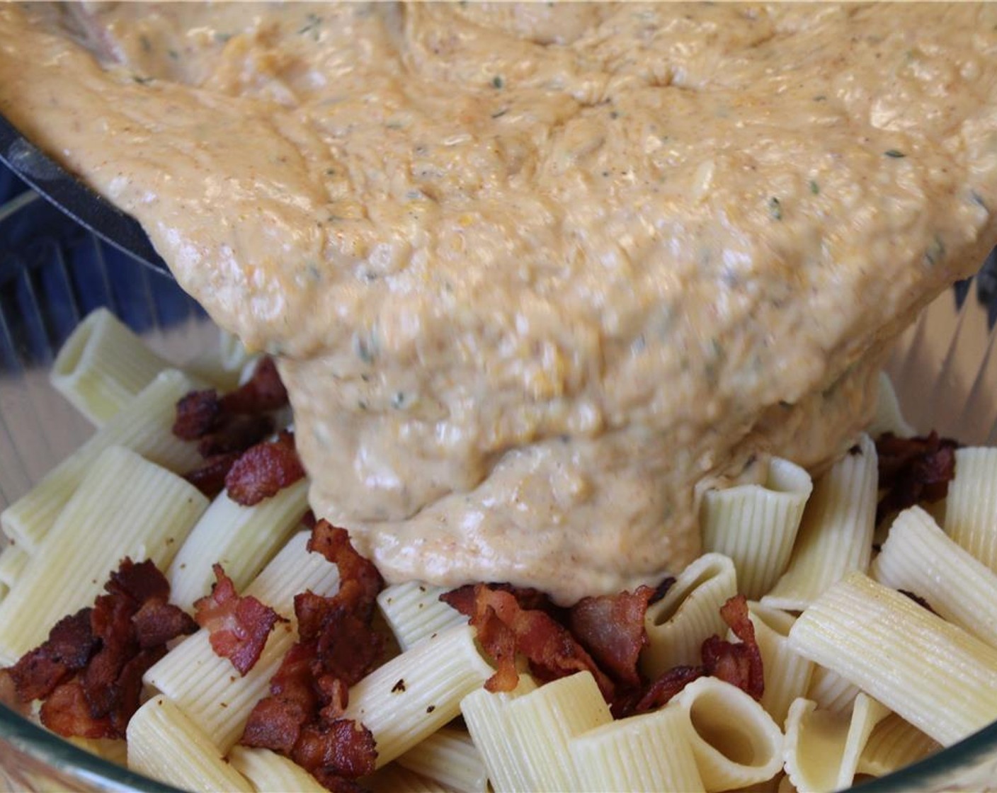 step 16 In a large bowl, combine the pasta, half the crisped bacon, and the sauce. Transfer the mixture to a greased baking dish.