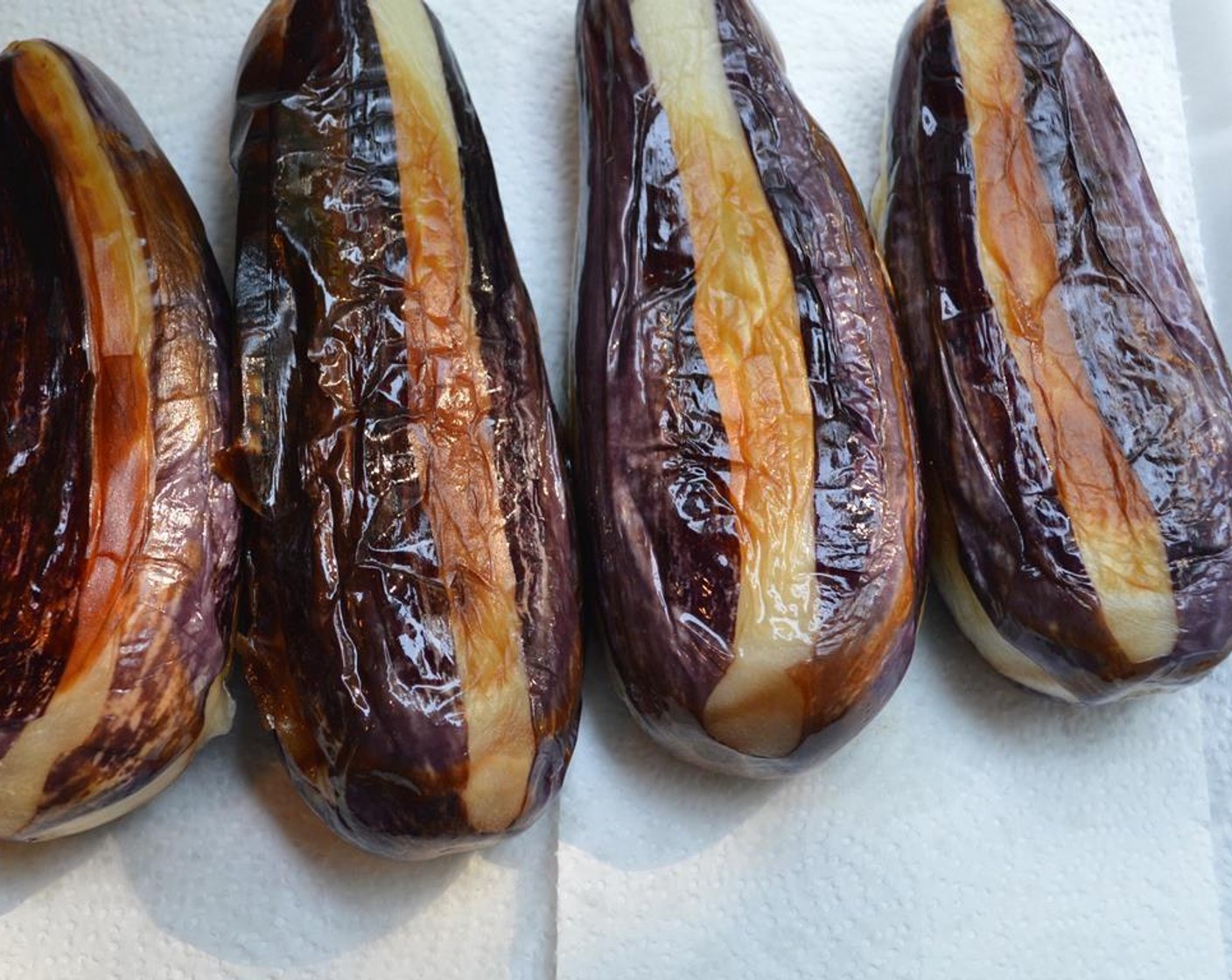 step 5 Remove eggplants onto a plate with paper towels to collect excess oil.