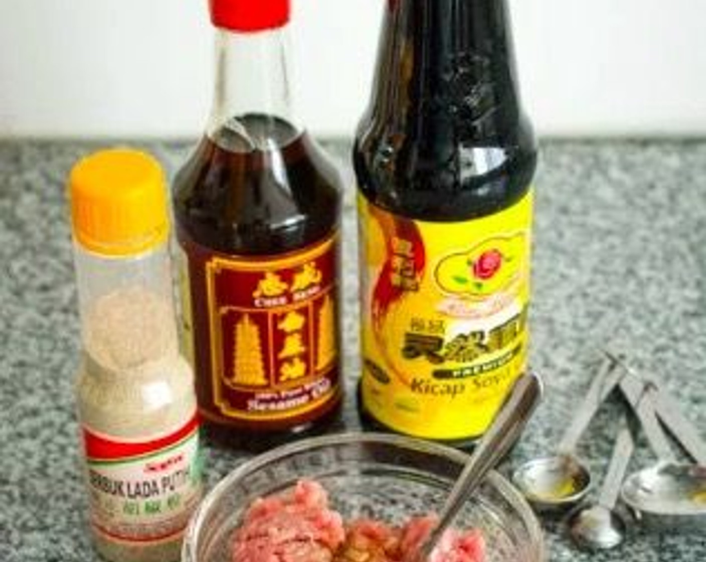 step 1 Marinate Ground Pork (8 oz) with Sesame Oil (1 tsp), Soy Sauce (1 tsp), and Ground White Pepper (2 dashes). Let it sit at room temperature for just a few minutes as you prepare the rest of the ingredients.