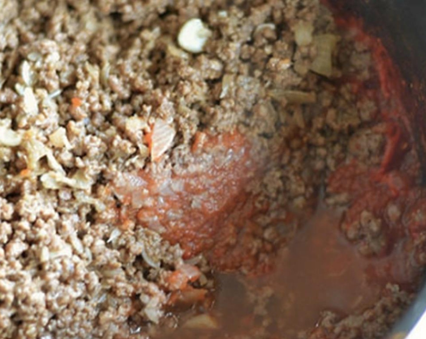 step 6 Add tomato sauce to meat.