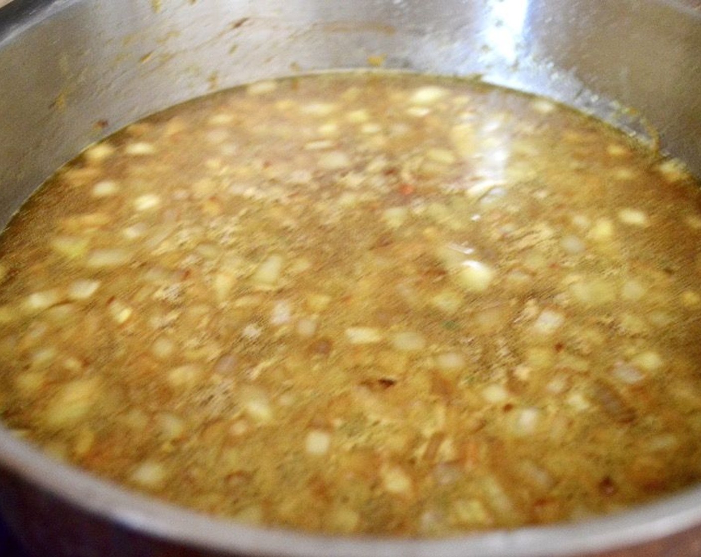 step 6 Add the Onion (1) and let it get fragrant for 1-2 minutes. Stir in the Long Grain White Rice (1 cup) and let it soften for about 30 seconds, then pour in the reserved marinade and Chicken Stock (2 1/3 cups). Let it come to a simmer, then add the chicken and the lemon back to the pan. Cover the pan with its lid and transfer it to the oven.