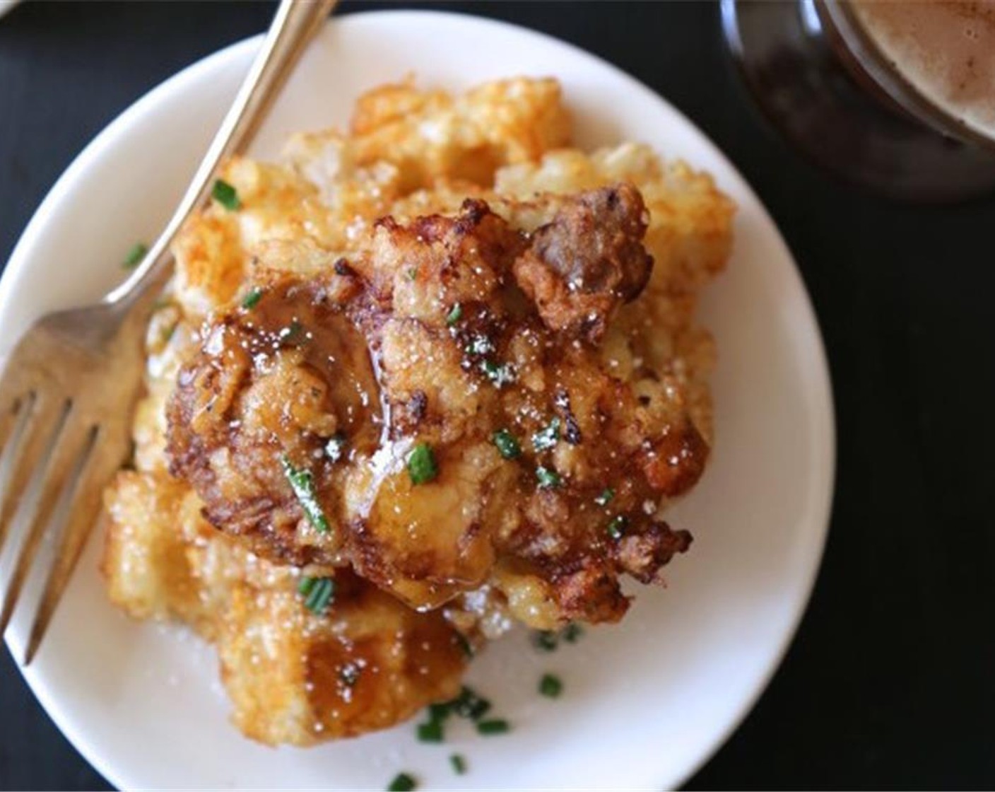 step 9 To serve, place two waffle-tot squares on a plate. Top with a piece of chicken or slice in half. Garnish with Honey (to taste), Fresh Parsley (to taste), Powdered Confectioners Sugar (to taste). Enjoy!